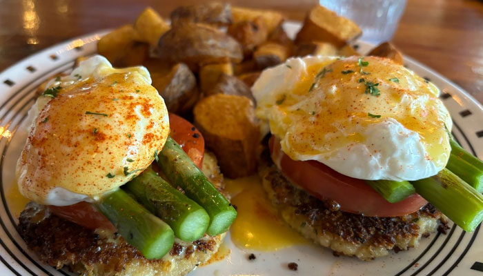 Eggs Benedict served with potatoes